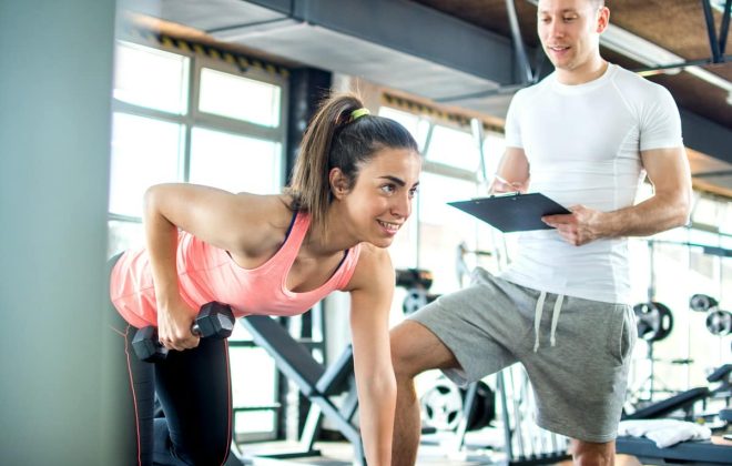 kobieta ćwicząca z trenerem