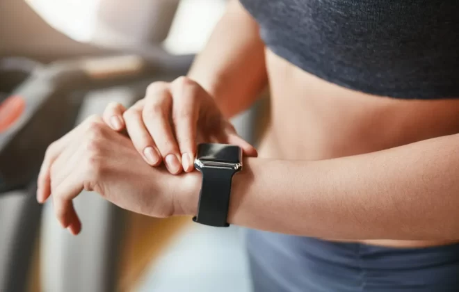 kobieta na siłowni sprawdzająca smartwatch